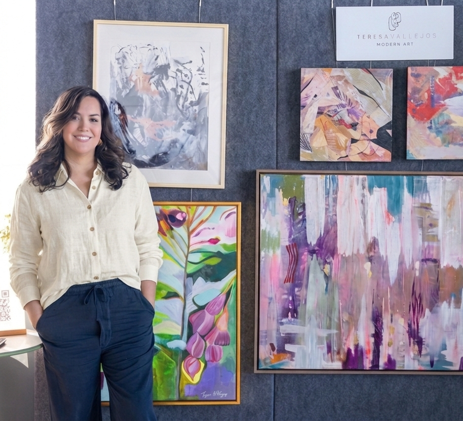 Teresa standing in front of wall with her paintings